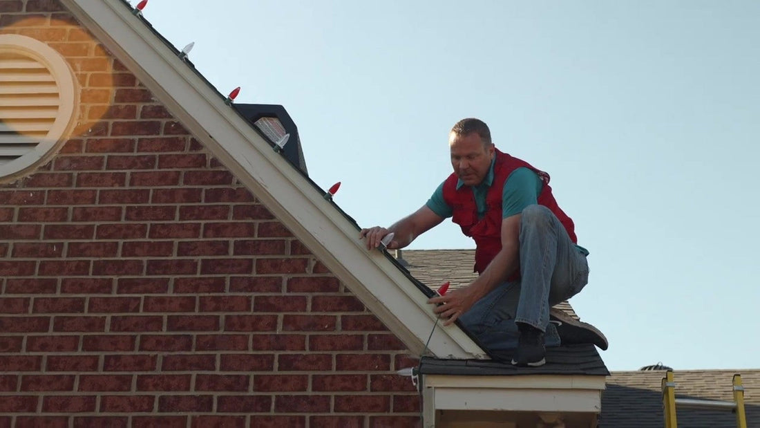 Still from "Christmas Lights Installation Video - Lets Get Lit Supply" (YouTube). Shingle edge clips beside brick are...