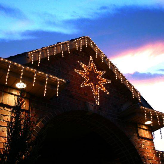 46in long Bethlehem Star wire frame with LED lights lit up on a house by Holidynamics
